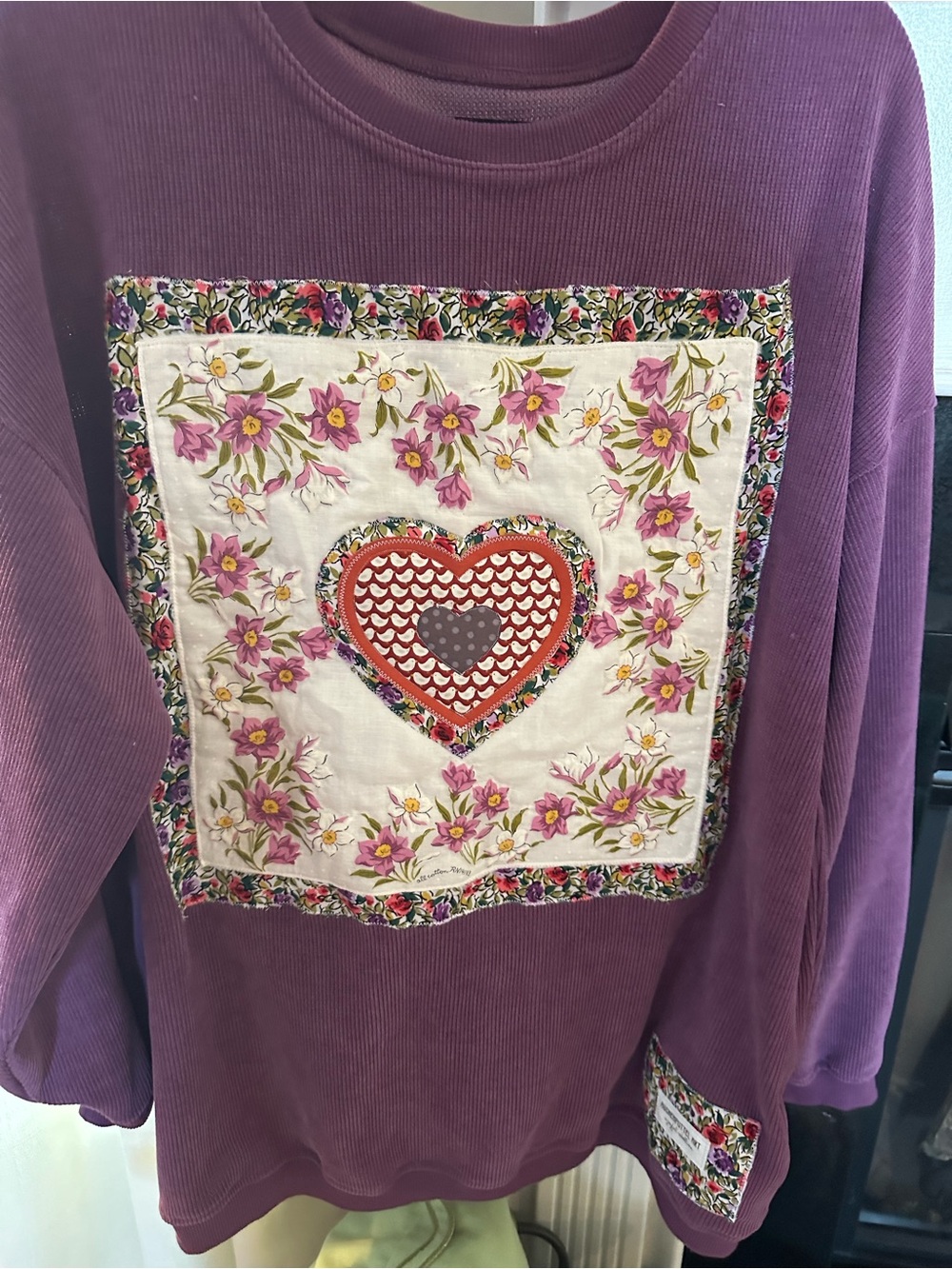 Purple ribbed sweatshirt with layered appliqué